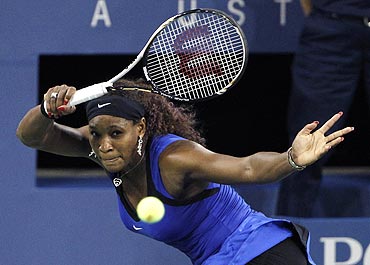 Serena Williams returns a volley to Caroline Wozniacki during the US Open semis on Saturday