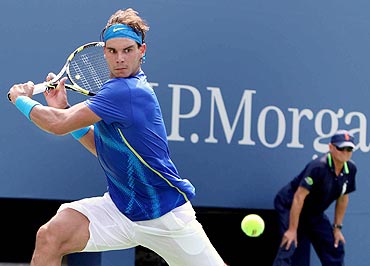 Rafa Nadal returns against Andy Murray during their semi-finals match on Saturday