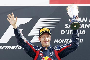 Red Bull Formula One driver Sebastian Vettel celebrates on the podium after winning the Italian F1 Grand Prix at Monza circuit on Sunday