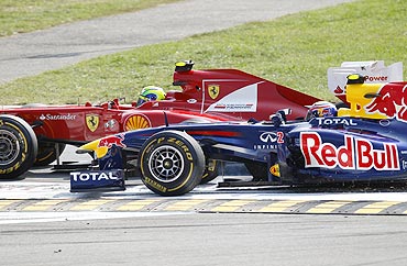 Ferrari Formula One driver Felipe Massa (left) collides with Red Bull's Mark Webber during the Italian F1 Grand Prix at the Monza circuit on Sunday