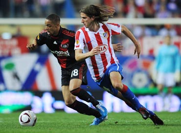 Filipe Luis (right) of Atletico Madrid duels for the ball with Sidney Sam of Bayer Leverkusen