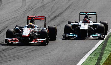 Mercedes's Michael Schumacher (right) and McLaren's Lewis Hamilton go head to head during the Italian Grand Prix on Sunday