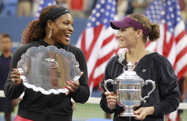 Serena Williams of the U.S. (L) and Samantha Stosur of Australia chat as they hold their trophies after Stosur defeated Williams to win the final of the U.S. Open