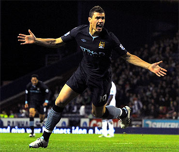 Manchester City's Edin Dzeko celebrates scoring a goal during the English Premier League match