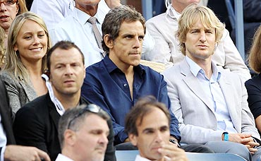 Actors Christine Taylor, Ben Stiller and Owen Wilson watch the US Open men's final between Rafael Nadal and Novak Djokovic