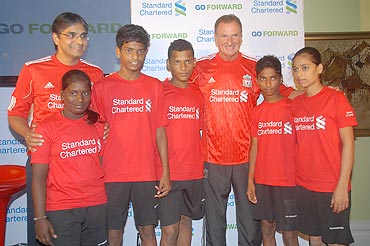 Phil Thompson and Sreeram Iyer, Regional COO, India and South Asia, Standard Chartered Bank, (extreme left) with the children representing Mumbai's municipal schools at the launch of the 'GO FORWARD' program at a city hotel on Wednesday