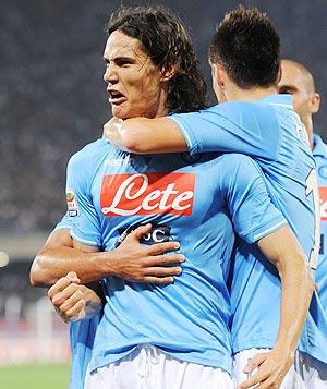 Edinson Cavani of Napoli celebrates with teammates after scoring against AC Milan on Sunday