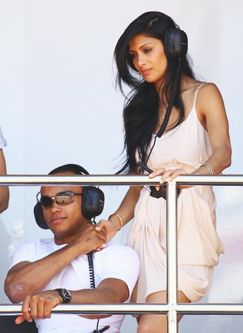 Nicole SAcherzinger of the Pussycat Dolls, girlfriend of Lewis Hamilton of Great Britain and McLaren Mercedes, is seen with Nic Hamilton, brother of Lewis
