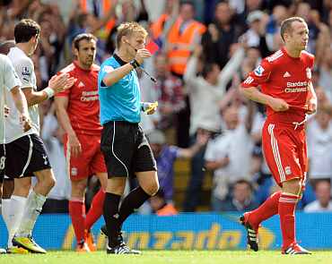 Liverpool's Charlie Adam recieves a red card from referee