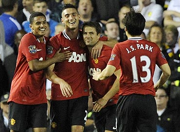 Manchester United's Michael Owen celebrates with teammates after scoring against Leeds United on Tuesday