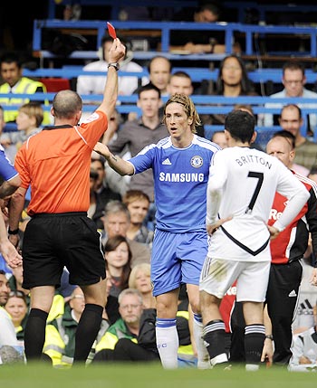 Chelsea's Fernando Torres is shown a red card by referee Mike Dean during the English Premier League soccer match against Swansea City at Stamford bridge in London, on Saturday