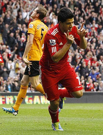 Liverpool's Luis Suarez (R) celebrates after scoring during their English Premier League soccer match against Wolverhampton Wanderers