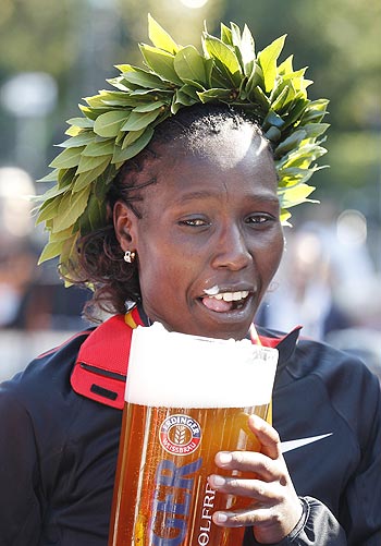 Florence Kiplagat of Kenya tastes German alcohol-free beer after winning the Berlin Marathon on Sunday