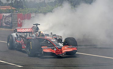 McLaren Formula One driver Lewis Hamilton does a burn-out in an F1 car on an unused section of the Banglore-Mysore highway on Tuesday