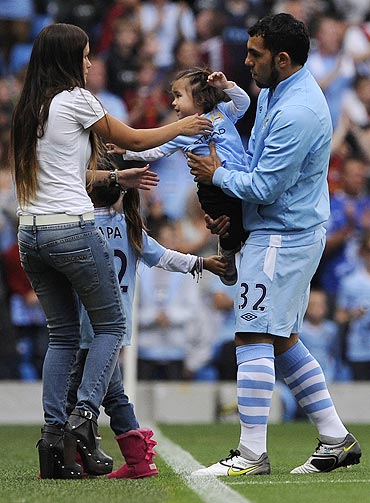 Manchester City's Carlos Tevez (right) with his children and wife Vanessa