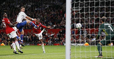 Manchester United's Ashley Young (2nd from right) heads a goal against FC Basel