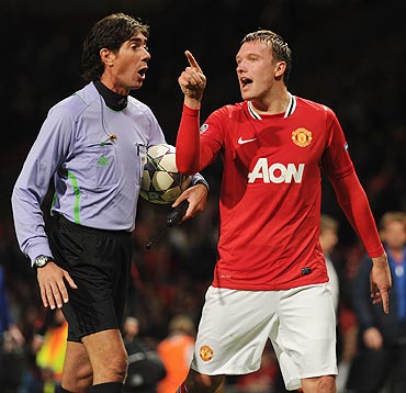 Manchester United's Phil Jones argues with a match official