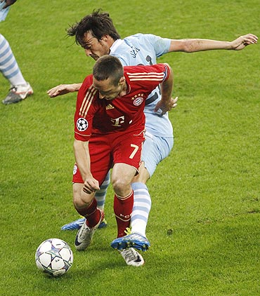 Bayern Munich's Franck Ribery (left) is tackled by Manchester City's David Silva