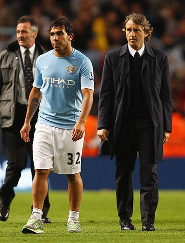 Carlos Tevez with Manchester City coach Roberto Mancini