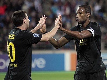 Barcelona's Lionel Messi (left) and Seydou Keita celebrate a goal