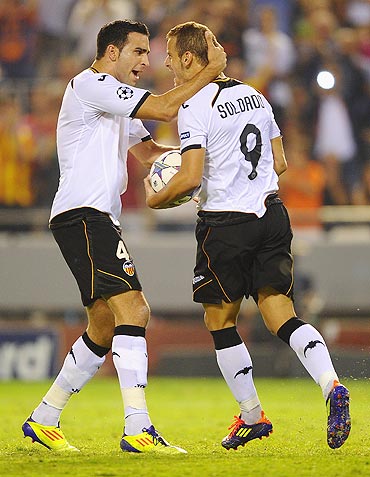 Roberto Soldado of Valencia celebrates with teammate Adil Rami (left) after scoring from the penalty spot