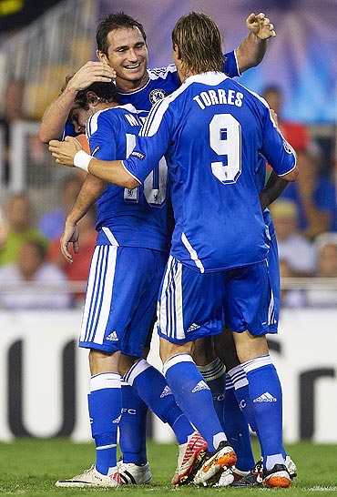 Frank Lampard celebrates with teammates after scoring against Valencia