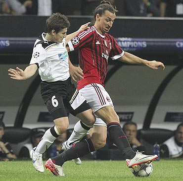 AC Milan's Zlatan Ibrahimovic is challenged by Viktoria Plzen's Vaclav Pilar