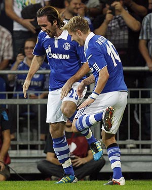 Schalke 04's Christian Fuchs and teammate Lewis Holtby (right) break into a jig as they celebrate after the former scored against Maccabi Haifa during their Europa League match on Thursday