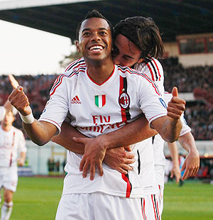 Robinho of Milan celebrates with a teammate after scoring the opening goal during the Serie A match between against Catania Calcio at Stadio Angelo Massimino on Saturday