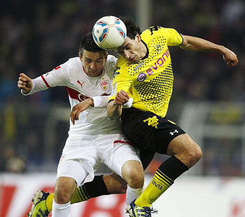 Borussia Dortmund's Hummels and Stuttgart's Ibisevic head a ball during their Bundesliga match in Dortmund