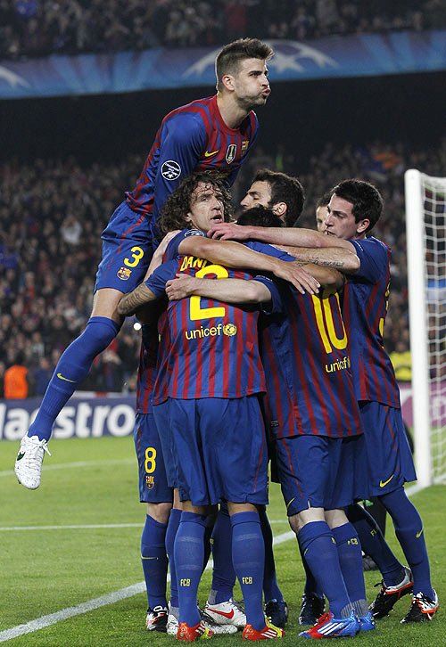 Barcelona's Pique celebrates with team-mates after Messi scored a penalty against AC Milan