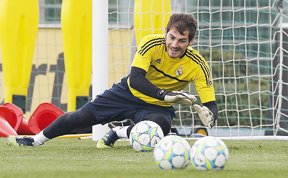 Goalkeeper Iker Casillas of Real Madrid dives for a ball during a training session