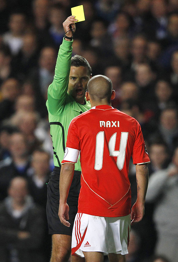 Benfica's Maxi Pereira is shown the yellow card during their Champions League match against Chelsea on Wedneday