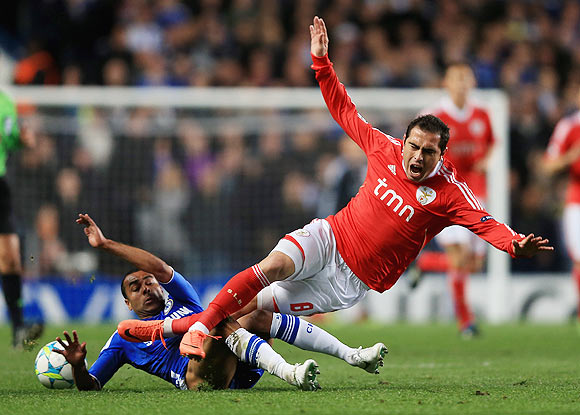 Chelsea's Ashley Cole challenges Benfica's Bruno Cesar during their match on Wednesday