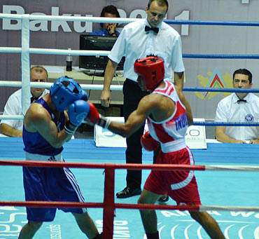 Vikas Krishnan Yadav lands a punch on his opponent
