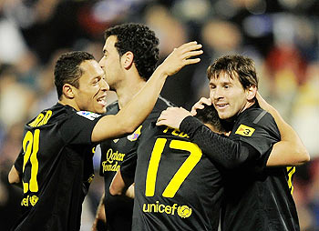 Lionel Messi (right) and Alexis Sanchez (left) of FC Barcelona congratulate Pedro Rodriguez (No.17) after Rodriguez scored Barcelona's 4th goal