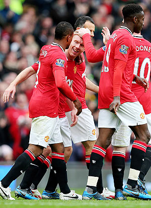 Paul Scholes of Manchester United is congratulated by his team-mates