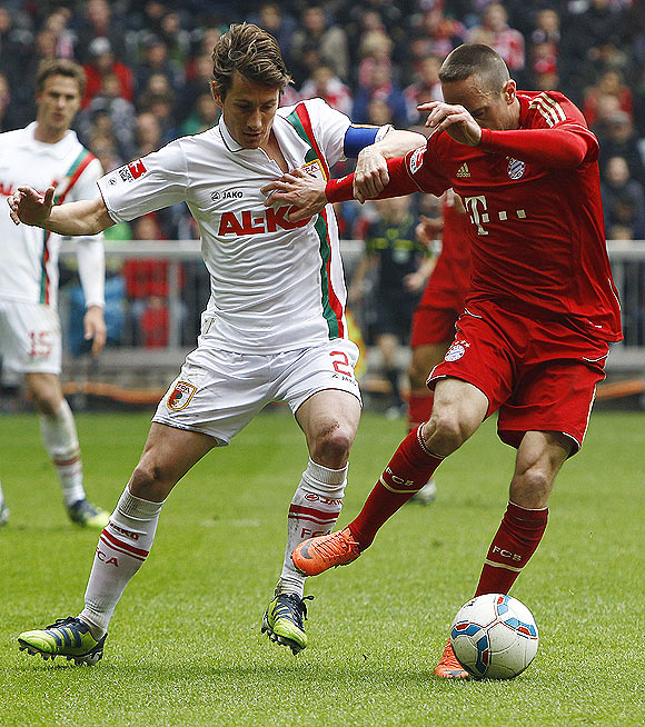 Bayern Munich's Franck Ribery (right) challenges Augsburg's Paul Verhaegh as they vie for possession during their Bundesliga match played on Saturday