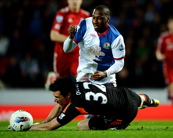 Liverpool's Alexander Doni brings down Junior Hoilett of Blackburn Rovers to concede a penalty