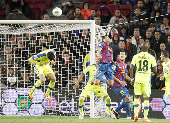 Barcelona's Pedro (17) heads the ball to score against Getafe