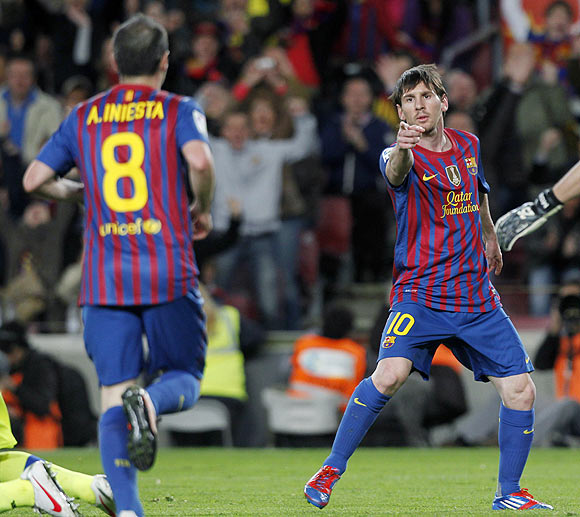 Barcelona's Lionel Messi (right) and Andres Iniesta celebrate a goal against Getafe