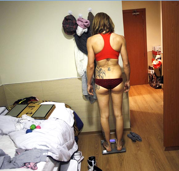 Spanish boxer Jennifer Miranda weighs herself on a scale at a high-performance sports centre in Los Alcazares, southeastern Spain