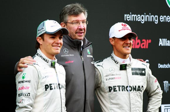 Michael Schumacher (right) with team-mate Nico Rosberg (left) and Mercedes team principal Ross Brawn