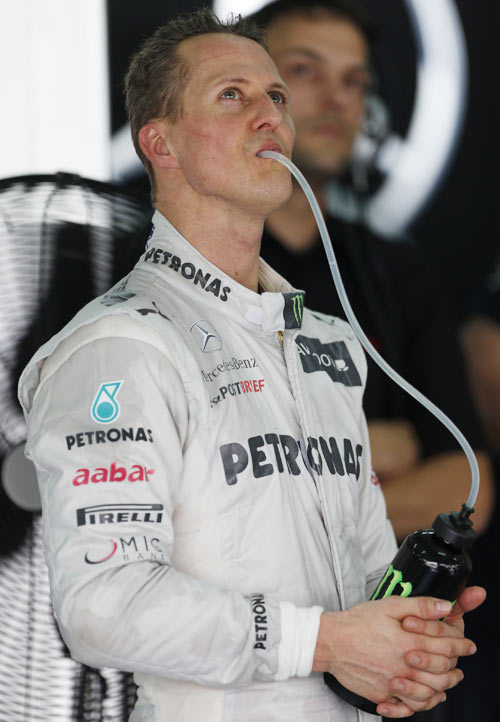 Mercedes Formula One driver Michael Schumacher of Germany looks at monitor