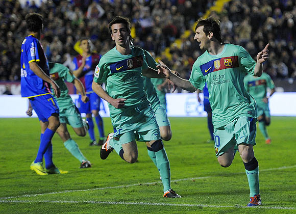 Barcelona's Lionel Messi (right) celebrates after scoring against Levante during their La Liga match on Saturday