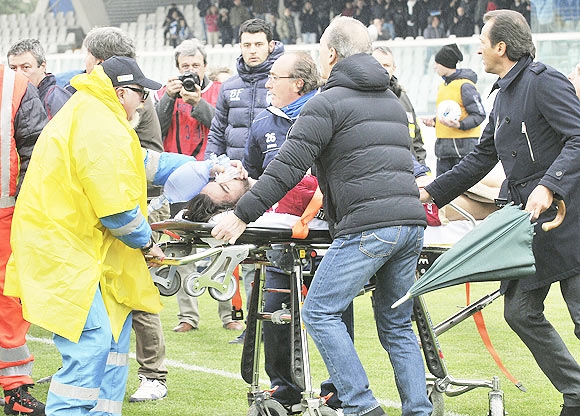 Livorno's Piermario Morosini is helped by doctors as he is carried on a stretcher during their Serie B soccer match against Pescara at the Adriatico stadium in Pescara on Saturday