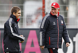 Bayern Munich's coach Jupp Heynckes (right) and Philipp Lahm arrive for a training session in Munich on Monday