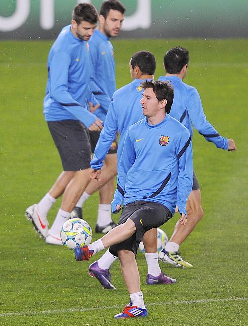 Lionel Messi of FC Barcelona passes the ball during a training session