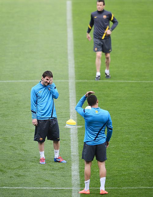 Lionel Messi of FC Barcelona jokes with a team-mate during a training session