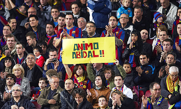 Barcelona fans display a banner in support of Eric Abidal